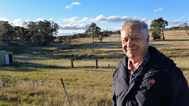 Man in front of old sapphire mining site Man in front of old sapphire mining site