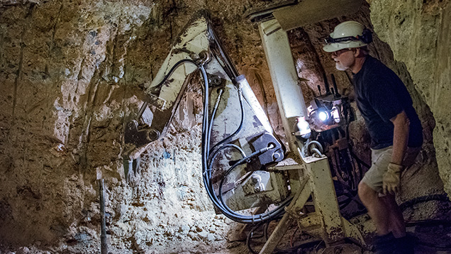 Man using digger underground Man using digger underground