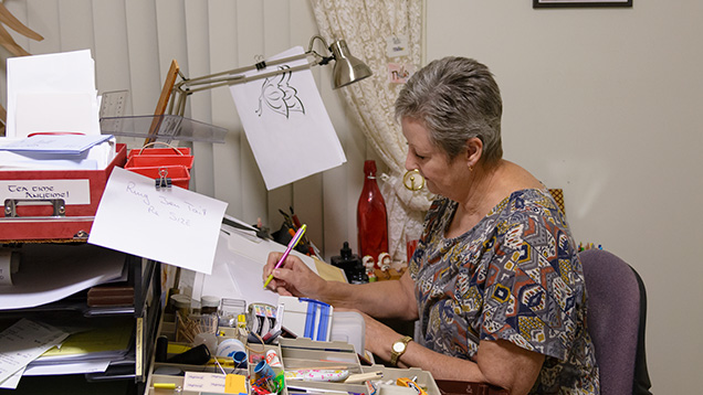 Woman sketching at desk Woman sketching at desk