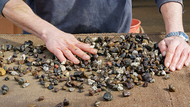 Miner picking sapphires Miner picking sapphires