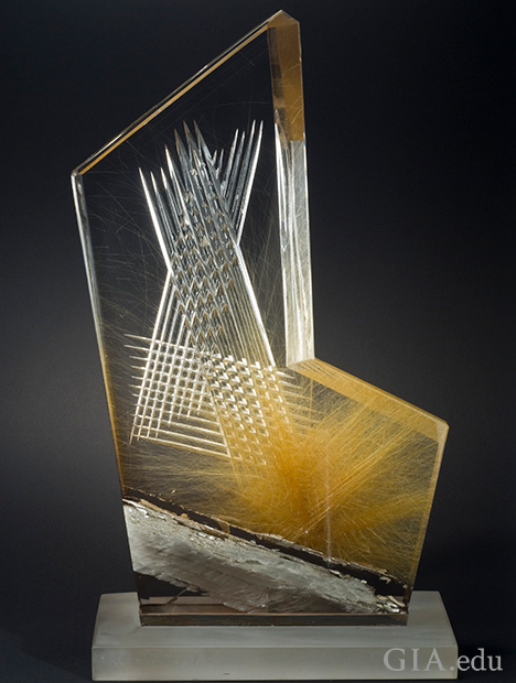 A piece of quartz with inclusions carved in x patterns.