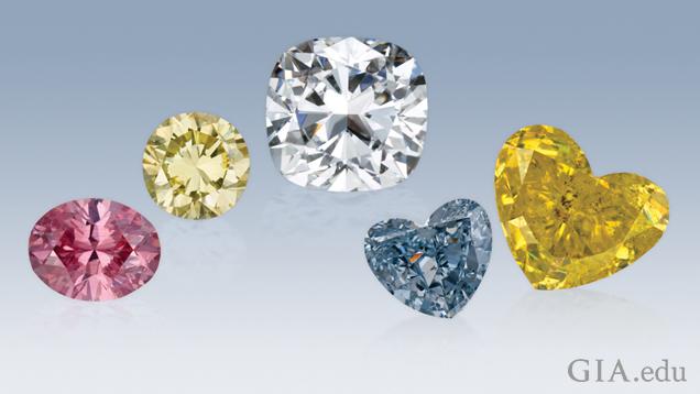 A pink round diamond, a yellow round diamond, a colorless cushion cut diamond, a blue heart shape diamond and a yellow heart shape diamond.