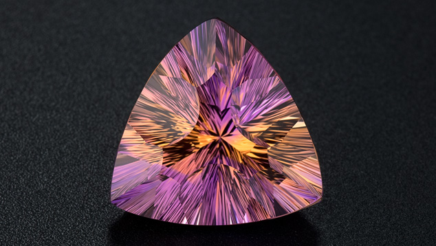 Ametrine Color Blend. This amazing ametrine trilliant cut features a multitude of facets to create internal reflections that blend the amethyst and citrine colors. Photo by Robert Weldon/GIA, courtesy Minerales y Metales del Oriente, Bolivia, SA.