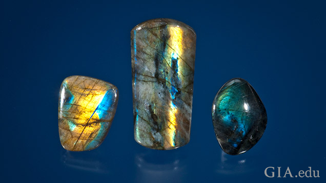 Three pieces of labradorite with yellow, blue and green flashes of color. Three pieces of labradorite with yellow, blue and green flashes of color.
