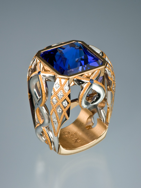 Intricate princess cut blue Tanzanite ring set in platinum inlay with gold accents Intricate princess cut blue Tanzanite ring set in platinum inlay with gold accents