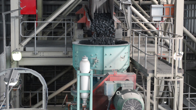 Kimberlite drops into a funnel shaped machine.