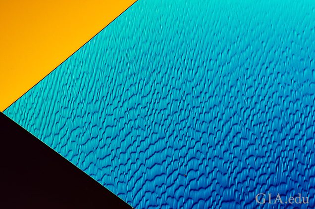 “Lizard skin” results from polishing a facet that lies nearly parallel to the octahedral face, which is the hardest crystal direction in diamond. Field of view 0.72 mm. “Lizard skin” results from polishing a facet that lies nearly parallel to the octahedral face, which is the hardest crystal direction in diamond. Field of view 0.72 mm.