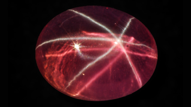 This pink synthetic sapphire showing a white six-rayed star and a pink star was purchased by one of the authors in Bangkok in 2010. The cabochon measures 14.4 × 11.2 mm and weighs 12.37 ct. Photo courtesy of M.P. Steinbach.