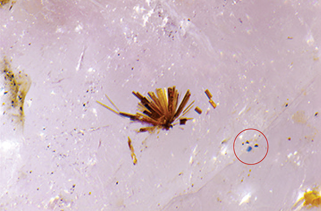 Needles and blue crystal deep within pezzottaite specimen. Needles and blue crystal deep within pezzottaite specimen.