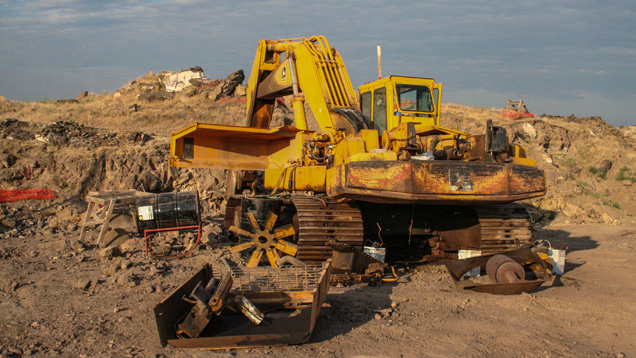 When we asked mine employee Mark Shore what it might take to fix this backhoe, he replied “about five sticks” (of dynamite!) - Duncan Pay When we asked mine employee Mark Shore what it might take to fix this backhoe, he replied “about five sticks” (of dynamite!) - Duncan Pay