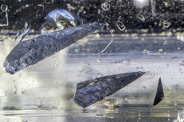Ferrocolumbite inclusions in this topaz resemble Star Wars star cruisers. Ferrocolumbite inclusions in this topaz resemble Star Wars star cruisers.