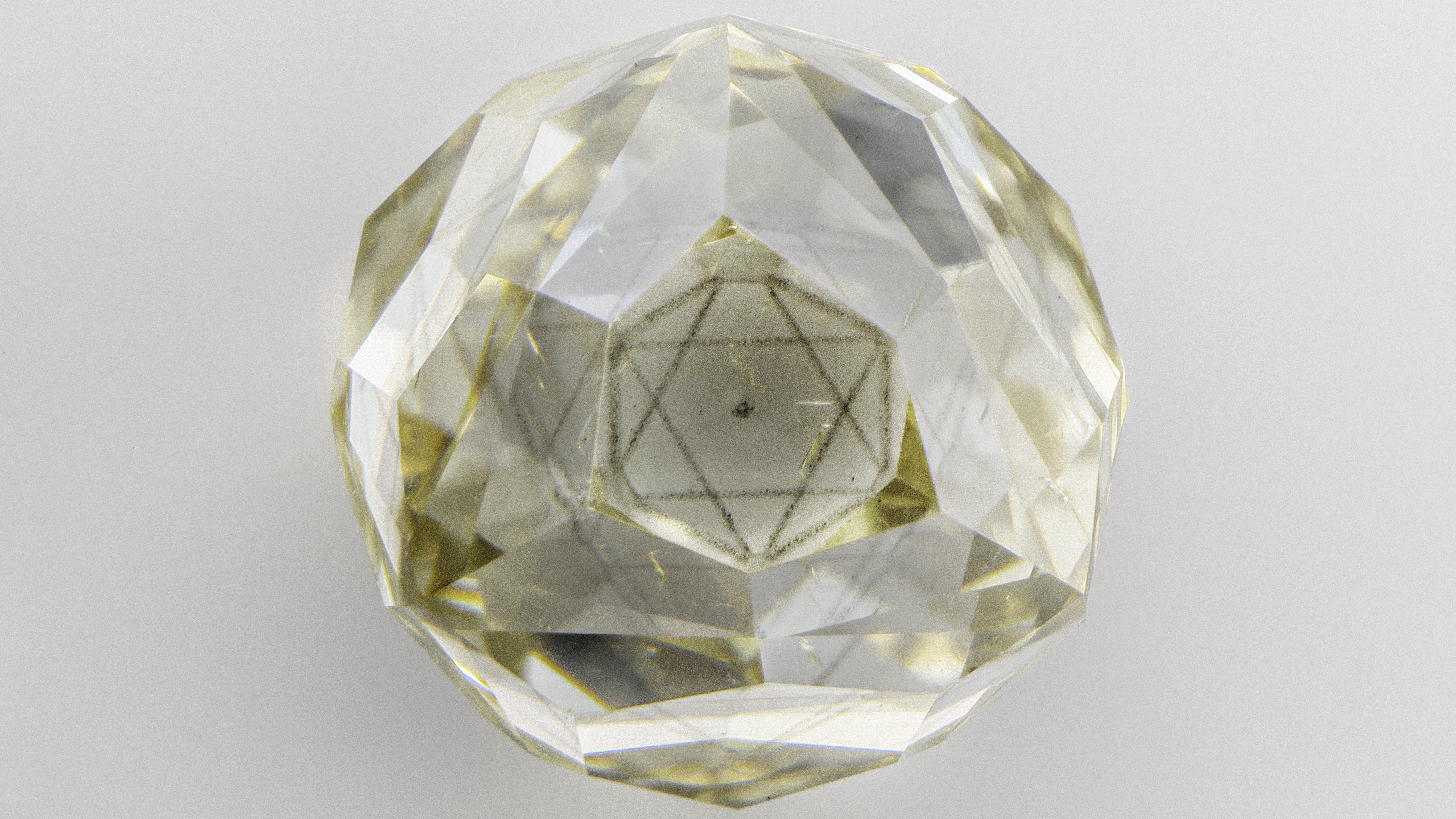 Octahedral-shaped cloud inclusion in a diamond octahedron. Octahedral-shaped cloud inclusion in a diamond octahedron.