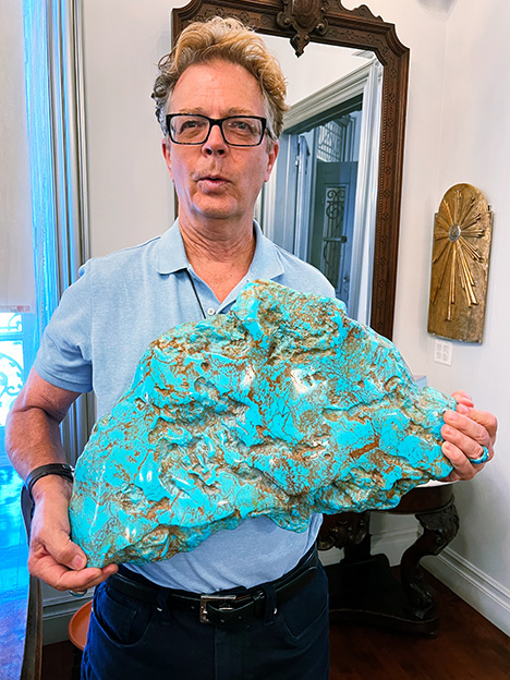 A massive resin imitation of turquoise held by Russell Twiford III.