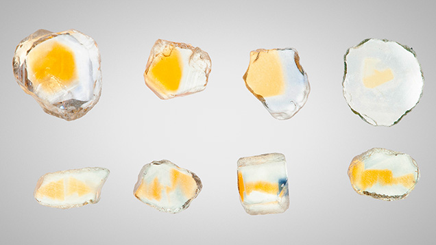 Figure 13. Sapphires from Rock Creek, Montana. The wafers in the top row are cut perpendicular to the c-axis and the wafers in the bottom row are cut parallel to the c-axis. These stones have been heat treated at 1200°C in oxygen. Photo by John L. Emmett.