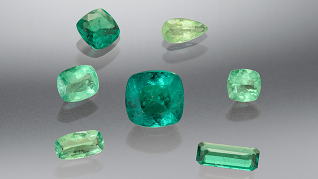 Figure 1. These seven stones (0.24–1.44 ct) ranging in color from yellowish green to bluish green were identified as the rare gem haüyne. Photo by Annie Haynes.