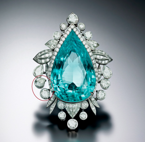 Figure 5. Another image output from Midjourney 5.2, using the prompt “watercolor style, pear-shaped Paraiba tourmaline brooch set in platinum with a halo of diamonds surrounding it.” Circled in red are irregularly shaped gems and “floating” bezels. Figure 5. Another image output from Midjourney 5.2, using the prompt “watercolor style, pear-shaped Paraiba tourmaline brooch set in platinum with a halo of diamonds surrounding it.” Circled in red are irregularly shaped gems and “floating” bezels.