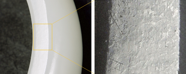 Figure 2. A section of a high-quality Russian white nephrite bracelet shows the distinctive orange peel effect, with lenticular contour ranging in size from 300 to 500 μm viewed under oblique illumination. Photo by Guanghai Shi. Figure 2. A section of a high-quality Russian white nephrite bracelet shows the distinctive orange peel effect, with lenticular contour ranging in size from 300 to 500 μm viewed under oblique illumination. Photo by Guanghai Shi.