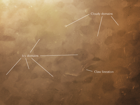 Figure 4. The polished surface of Russian white nephrite sample ELS27 showed icy domains (darker grains), cloudy domains (lighter grains), and claw lineation under oblique illumination with a sodium light source. Photomicrograph by Meiyu Shih; field of view 6.90 mm. Figure 4. The polished surface of Russian white nephrite sample ELS27 showed icy domains (darker grains), cloudy domains (lighter grains), and claw lineation under oblique illumination with a sodium light source. Photomicrograph by Meiyu Shih; field of view 6.90 mm.