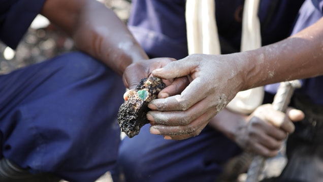 A worker at Gemfields’ Kagem mine in northern Zambia shows off a high-quality emerald embedded in matrix. The mine is the largest in Zambia and produces an estimated 20% of the world A worker at Gemfields’ Kagem mine in northern Zambia shows off a high-quality emerald embedded in matrix. The mine is the largest in Zambia and produces an estimated 20% of the world