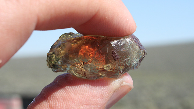 The rich glow of red from inside this rough Oregon sunstone hints at its potential as a fashioned gem. The rich glow of red from inside this rough Oregon sunstone hints at its potential as a fashioned gem.
