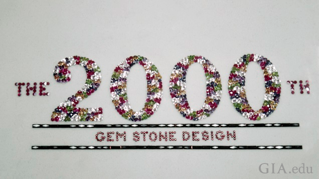 The gems spell out “The 2000th Gem Stone Design.” The gems spell out “The 2000th Gem Stone Design.”