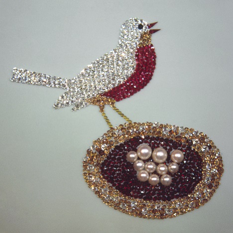 A bird stand on the rim of a nest filled with eggs. A bird stand on the rim of a nest filled with eggs.