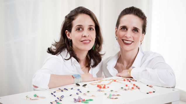 Sisters and Bahina Jewels owners Noëlle Vieillard-Jordi, left, and Annick Jordi, right, with a few of their designs. “Bahina” is a Hindi term meaning “two sisters.” Photo by Guy Perrenoud, courtesy Bahina Jewels Sisters and Bahina Jewels owners Noëlle Vieillard-Jordi, left, and Annick Jordi, right, with a few of their designs. “Bahina” is a Hindi term meaning “two sisters.” Photo by Guy Perrenoud, courtesy Bahina Jewels