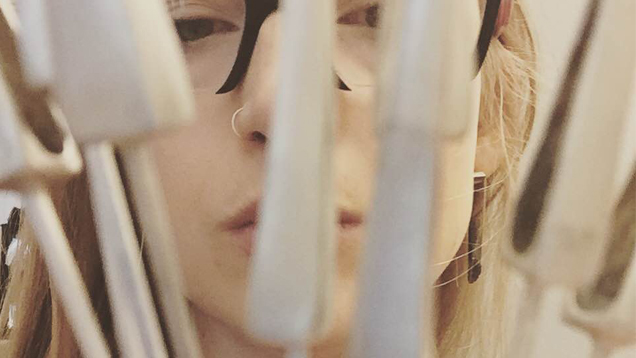 Grandics, wearing black-framed glasses, is behind a bouquet of point-shaped molds.