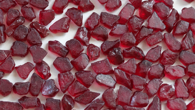 A close-up image of a pile of rough rubies A close-up image of a pile of rough rubies