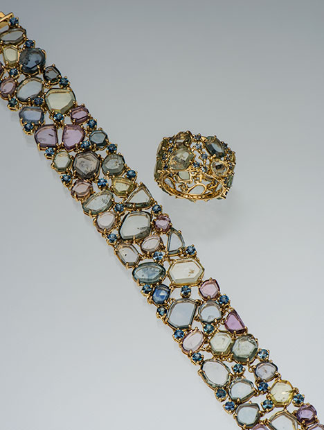 Rainbow Over Montana bracelet. Figure 1. The “Rainbow Over Montana” bracelet contains 76.83 carats of Montana sapphire (71.42 carats rough and 5.41 carats faceted). The ring from the same collection contains 11.57 carats of rough and 1.12 carats of faceted Montana sapphires. Photo by Robert Weldon/GIA; courtesy of Paula Crevoshay.