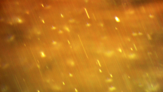 Photomicrograph of extremely fine needle-like particles in chrysoberyl
