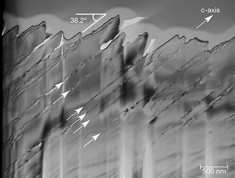 Planar defects in iridescent quartz face Planar defects in iridescent quartz face