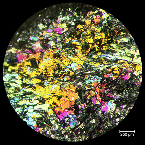 Reflected light microscope image of iridescent hematite. Reflected light microscope image of iridescent hematite.