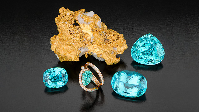 Paraíba-type tourmalines from Mozambique alongside gold nugget. Paraíba-type tourmalines from Mozambique alongside gold nugget.
