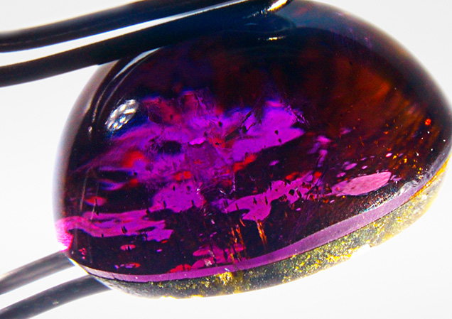 Side view shows the cemented plane of the cabochon assemblage. Side view shows the cemented plane of the cabochon assemblage.