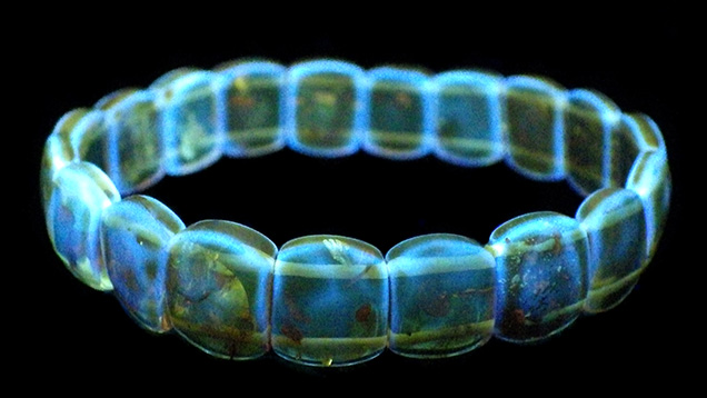 Amber bracelet with bright blue fluorescence. Amber bracelet with bright blue fluorescence.
