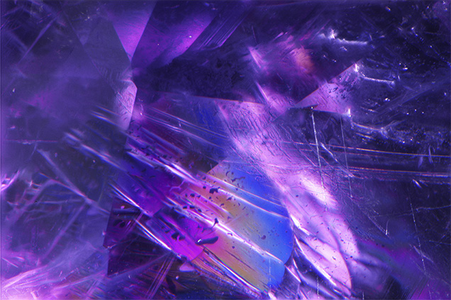 This faceted hexagonite contained iridescent cleavage cracks.