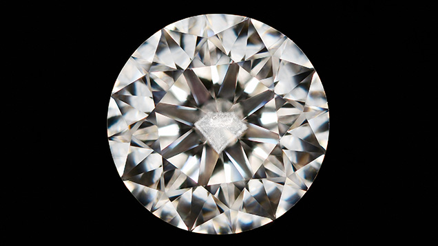 Round brilliant diamond featuring a diamond-shaped cloud inclusion. Round brilliant diamond featuring a diamond-shaped cloud inclusion.