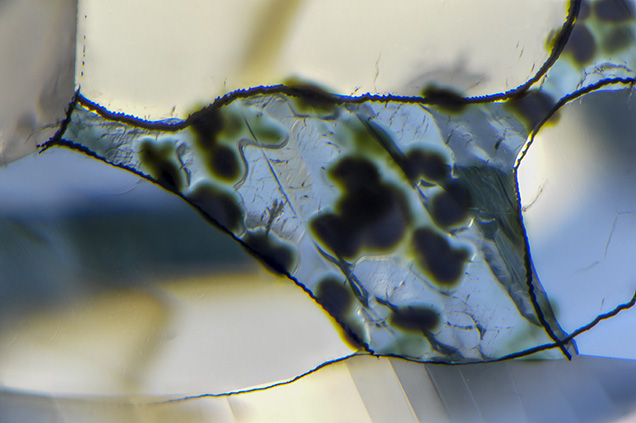 Diamond surface with dark green radiation stains. Diamond surface with dark green radiation stains.