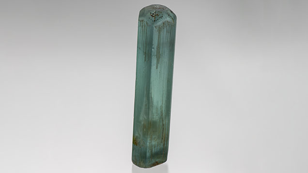 Figure 1. A 155 g aquamarine crystal containing a liquid and gas bubble inclusion. The crystal measures 11.9 cm long and the inclusion 4.3 cm long. Photo by Robert Weldon; courtesy of Kreis Jewellery GmbH. Figure 1. A 155 g aquamarine crystal containing a liquid and gas bubble inclusion. The crystal measures 11.9 cm long and the inclusion 4.3 cm long. Photo by Robert Weldon; courtesy of Kreis Jewellery GmbH.