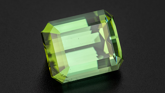 Figure 1. A 16.96 ct emerald-cut green tourmaline from rough found near a new pocket at the Tourmaline King mine. Photo by Robert Weldon; courtesy of Pala International. Figure 1. A 16.96 ct emerald-cut green tourmaline from rough found near a new pocket at the Tourmaline King mine. Photo by Robert Weldon; courtesy of Pala International.