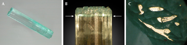 Figure 15. A: Sample 15 (37.4 mm in length), an emerald crystal with color zoning; at one end, the sample reveals a continuous rim surrounding growth areas ending in small basal faces. B: Growth and color zoning (arrows) of the crystal along the c-axis. C: Areas of the rim and small columns inside the rim with planes parallel to the basal pinacoid appear bright in reflected light, viewed parallel to the c-axis. Photos by K. Schmetzer; field of view 3.6 mm (C).