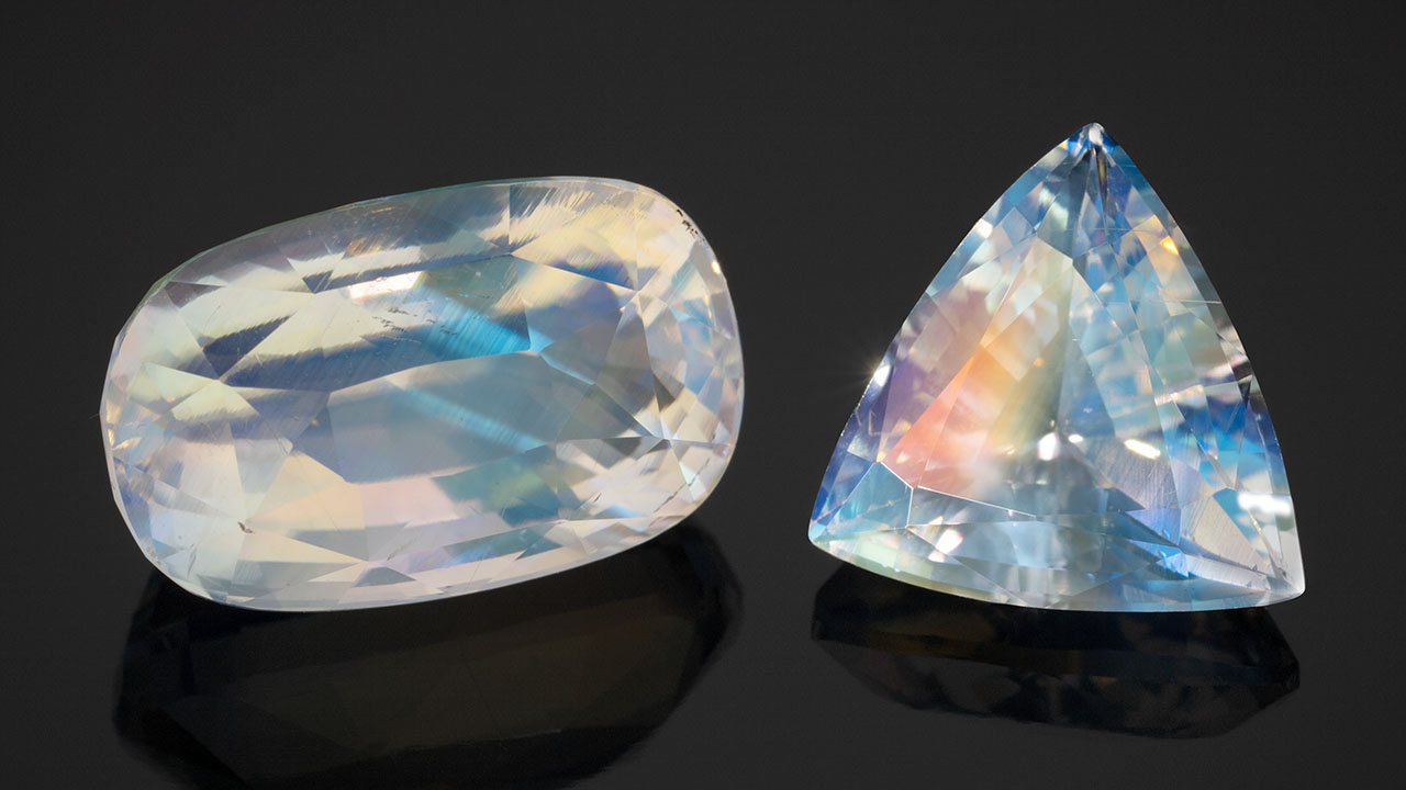 A 9.30 ct oval cut and a 4.12 ct triangular cut of a new type of moonstone from Madagascar featuring an orange flash effect. Photo by Robert Weldon; courtesy of Dudley Blauwet Gems. A 9.30 ct oval cut and a 4.12 ct triangular cut of a new type of moonstone from Madagascar featuring an orange flash effect. Photo by Robert Weldon; courtesy of Dudley Blauwet Gems.