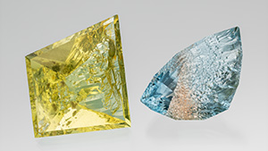 Figure 1. This 109.68 ct heliodor and 80.62 ct bicolor topaz are from the Volyn deposit in Ukraine. They are cut to leave natural etch faces on the pavilion/culet, while the crown and table are faceted. Photo by Robert Weldon; courtesy of Nomad’s. Figure 1. This 109.68 ct heliodor and 80.62 ct bicolor topaz are from the Volyn deposit in Ukraine. They are cut to leave natural etch faces on the pavilion/culet, while the crown and table are faceted. Photo by Robert Weldon; courtesy of Nomad’s.