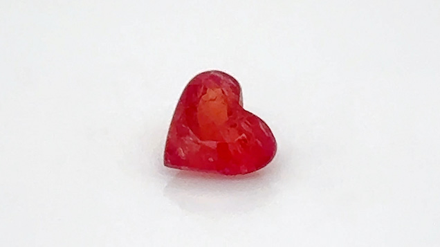 Figure 7. A 0.67 ct heart-shaped pezzottaite measuring 5.61 × 6.10 mm. The rough of this rare newer gem material was found and bought in Madagascar in December 2023. The stone was cut in New York for the Tucson show, where it sold. Photo by Kalim Corey; courtesy of Caroline C. Figure 7. A 0.67 ct heart-shaped pezzottaite measuring 5.61 × 6.10 mm. The rough of this rare newer gem material was found and bought in Madagascar in December 2023. The stone was cut in New York for the Tucson show, where it sold. Photo by Kalim Corey; courtesy of Caroline C.