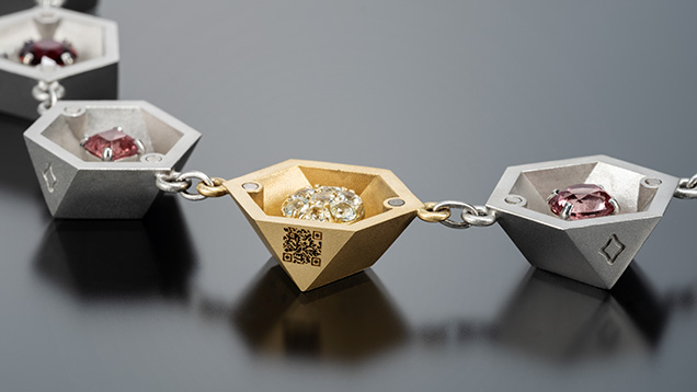 Figure 3. The 18K gold half link features a QR code that leads to a website with details about the garnets and the necklace’s creation. Photo by Robert Weldon; courtesy of Mary van der Aa Fine Jewels and Tucson Todd’s Gems. Figure 3. The 18K gold half link features a QR code that leads to a website with details about the garnets and the necklace’s creation. Photo by Robert Weldon; courtesy of Mary van der Aa Fine Jewels and Tucson Todd’s Gems.