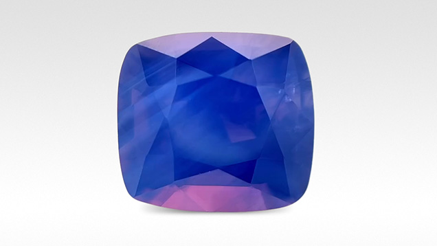 Figure 3. An exceptional 5.02 ct, 9.9 × 9.0 mm opalescent blue sapphire from An Phu, Vietnam, with eye-visible bands of silk in addition to pink and orange flashes reminiscent of play-of-color in opal from Australia. Photo by Anna Merritt; courtesy of Dudley Blauwet Gems. Figure 3. An exceptional 5.02 ct, 9.9 × 9.0 mm opalescent blue sapphire from An Phu, Vietnam, with eye-visible bands of silk in addition to pink and orange flashes reminiscent of play-of-color in opal from Australia. Photo by Anna Merritt; courtesy of Dudley Blauwet Gems.
