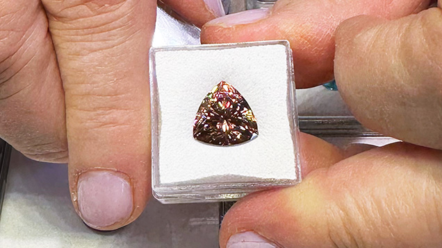 Figure 5. An 11.7 mm, 8.34 ct “mocha” zircon trillion. Photo by Jennifer Stone-Sundberg; courtesy of Mayer & Watt. Figure 5. An 11.7 mm, 8.34 ct “mocha” zircon trillion. Photo by Jennifer Stone-Sundberg; courtesy of Mayer & Watt.