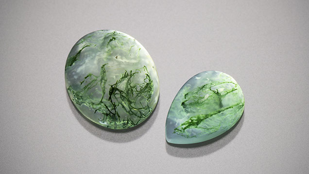 Figure 9. Moss agate cabochons measuring 12 × 10 mm (left) and 10 × 7 mm (right). Photo by Kevin Schumacher; courtesy of Columbia Gem House. Figure 9. Moss agate cabochons measuring 12 × 10 mm (left) and 10 × 7 mm (right). Photo by Kevin Schumacher; courtesy of Columbia Gem House.