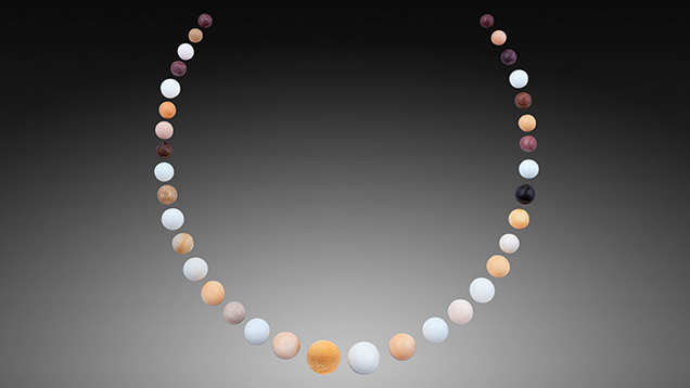 Figure 2. The 35 near-round and round non-nacreous pearls, 482.01 carats total, arranged in a necklace layout. Photo by Nuttapol Kitdee. Figure 2. The 35 near-round and round non-nacreous pearls, 482.01 carats total, arranged in a necklace layout. Photo by Nuttapol Kitdee.